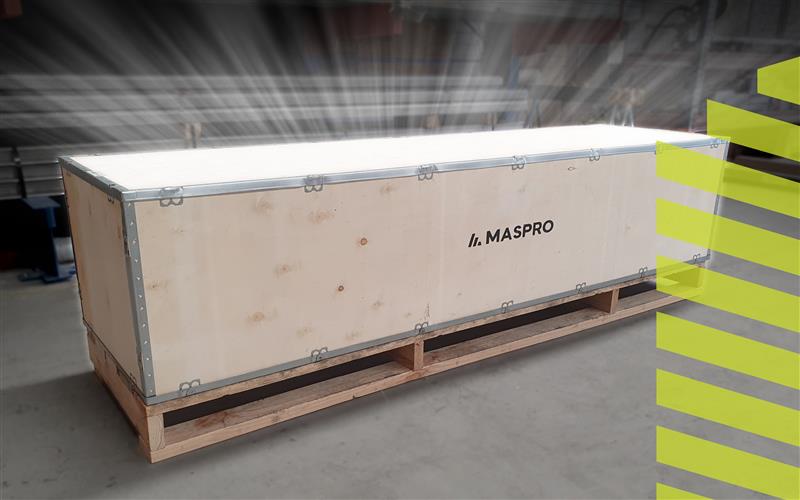 A large wooden shipping crate branded with the MASPRO logo, illuminated from above with glowing light rays, symbolising quality and innovation in manufacturing.