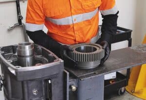 MASPRO technician installing a precision-engineered rotation head component during workshop assembly