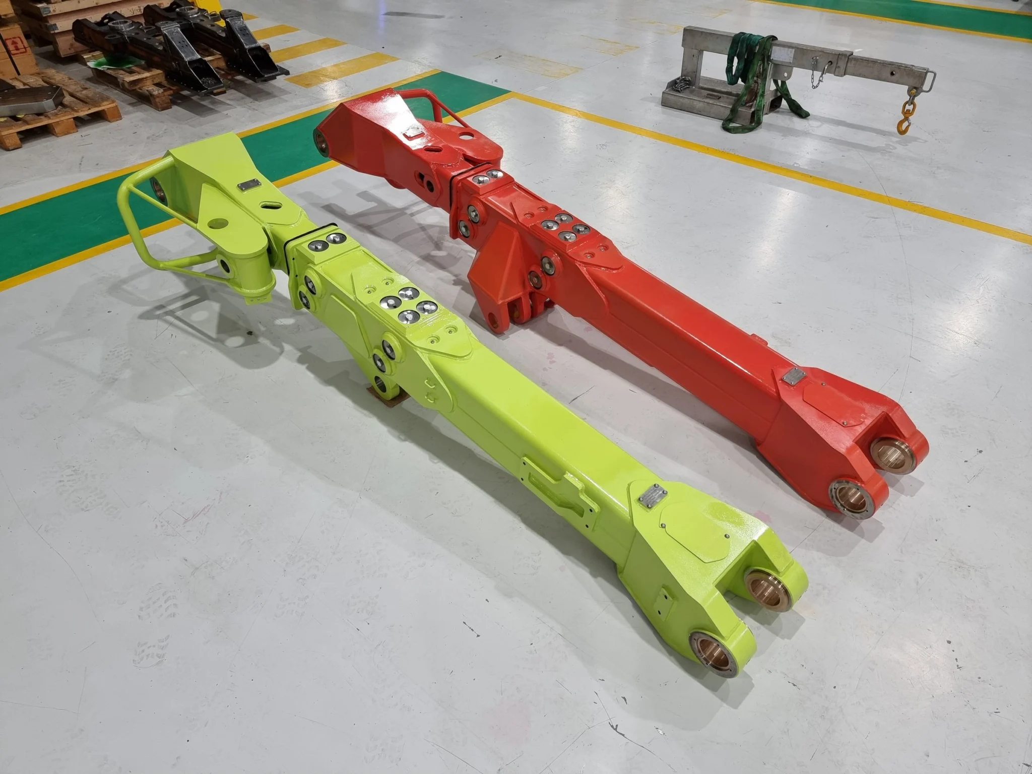 Multiple cradle and component assemblies displayed in rows on workshop floor.